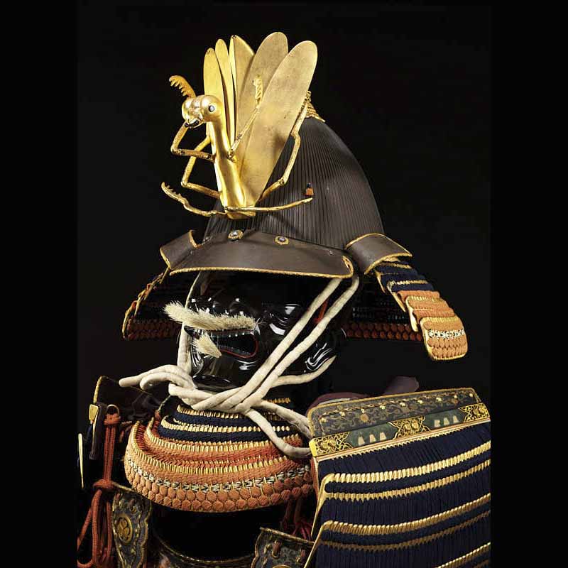 detail of samurai warrior helmet with praying mantis figure